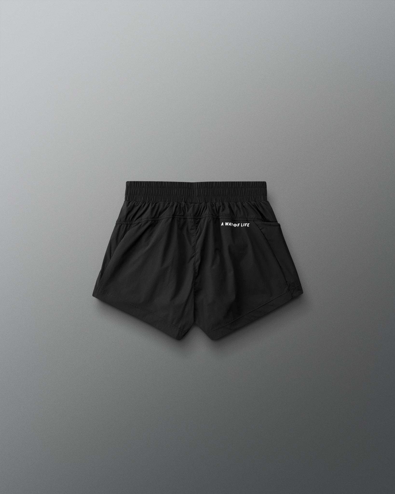 Black shorts with a brand logo on a gray background