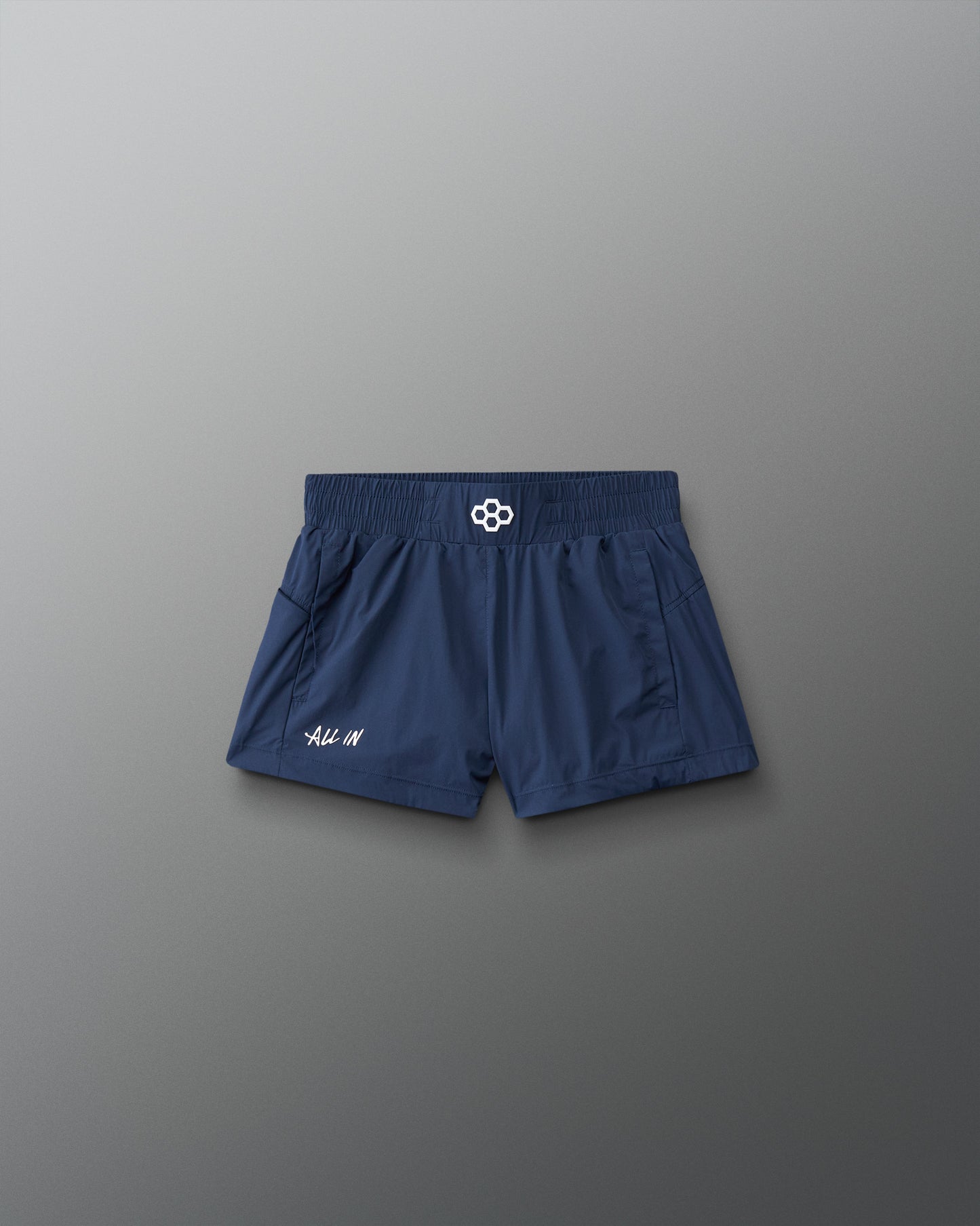 Navy blue shorts with a brand logo on a gray background
