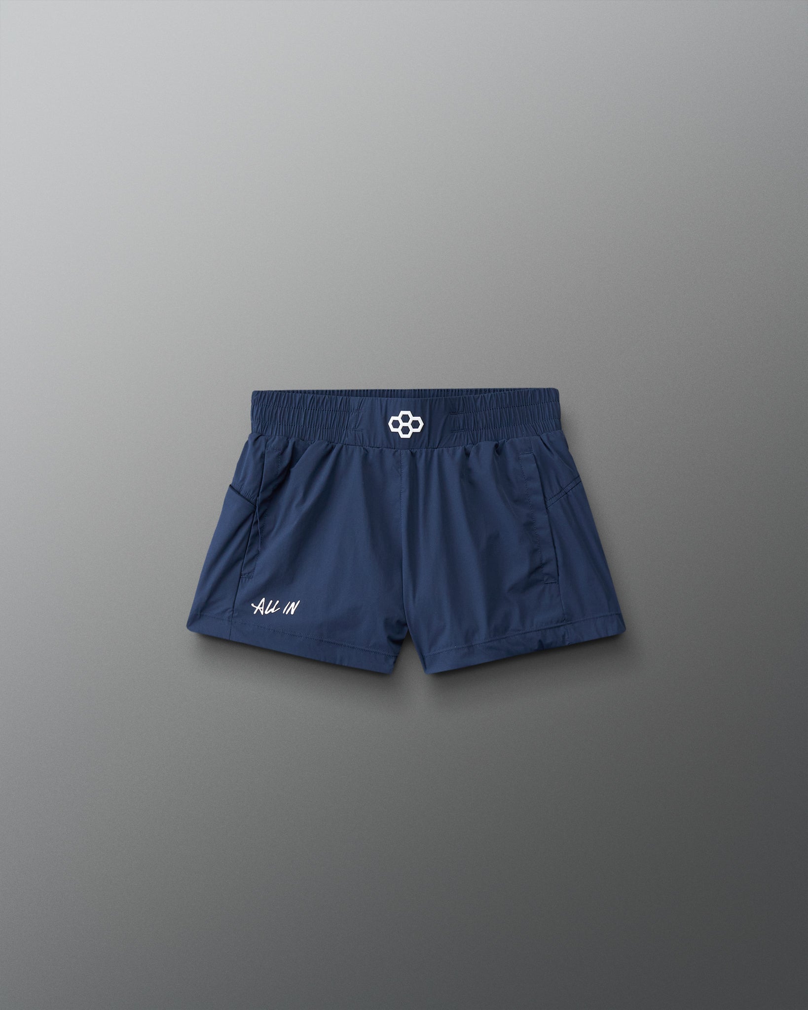 Navy blue shorts with a brand logo on a gray background