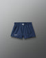 Navy blue shorts with a brand logo on a gray background