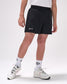 Person wearing black shorts with 'All In' text, white socks, and white sneakers on a light gray background
