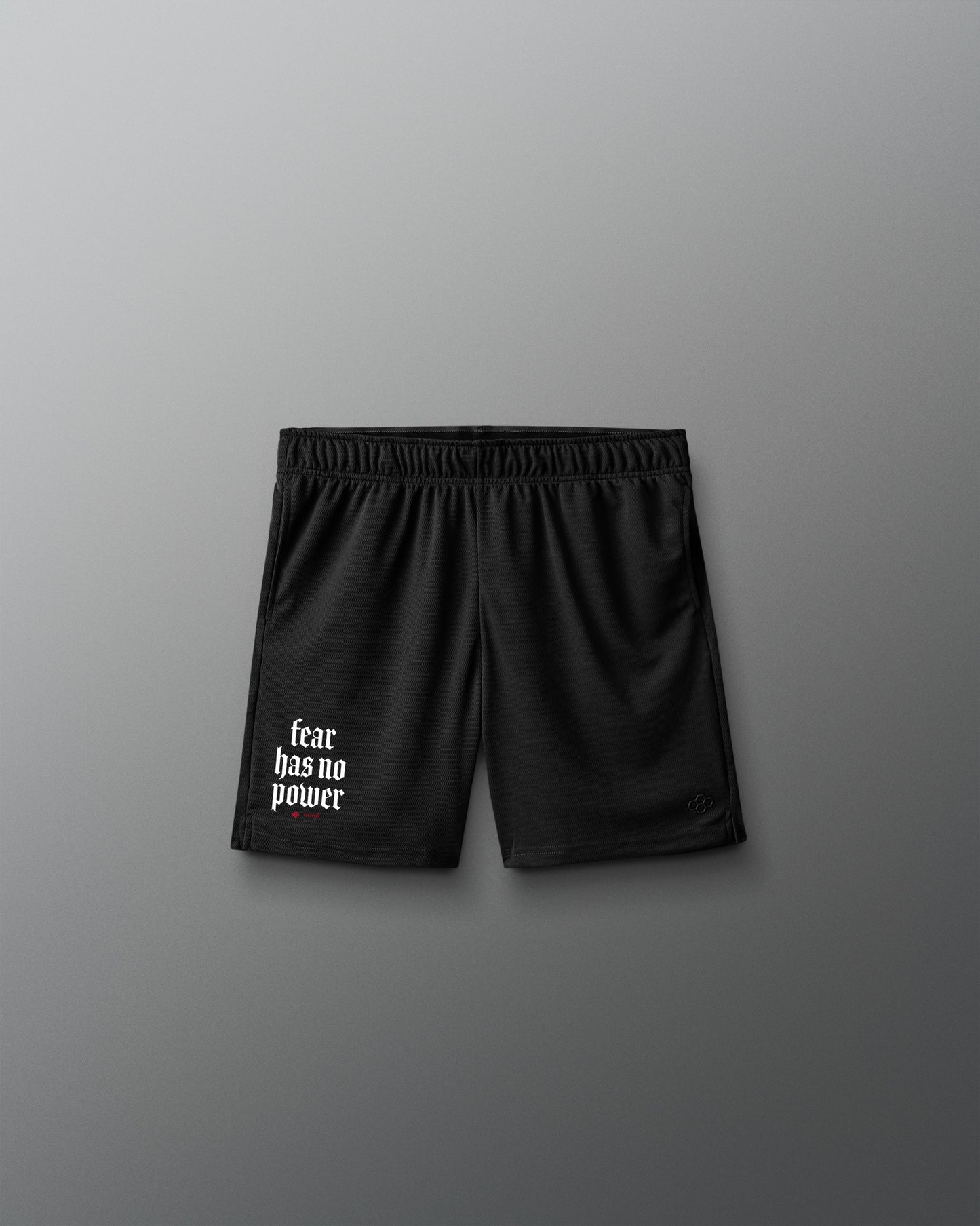 Black shorts with 'fear has no power' text on a gray background