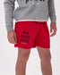 Person wearing red shorts with 'fear has no power' text and a gray sweatshirt on a white background