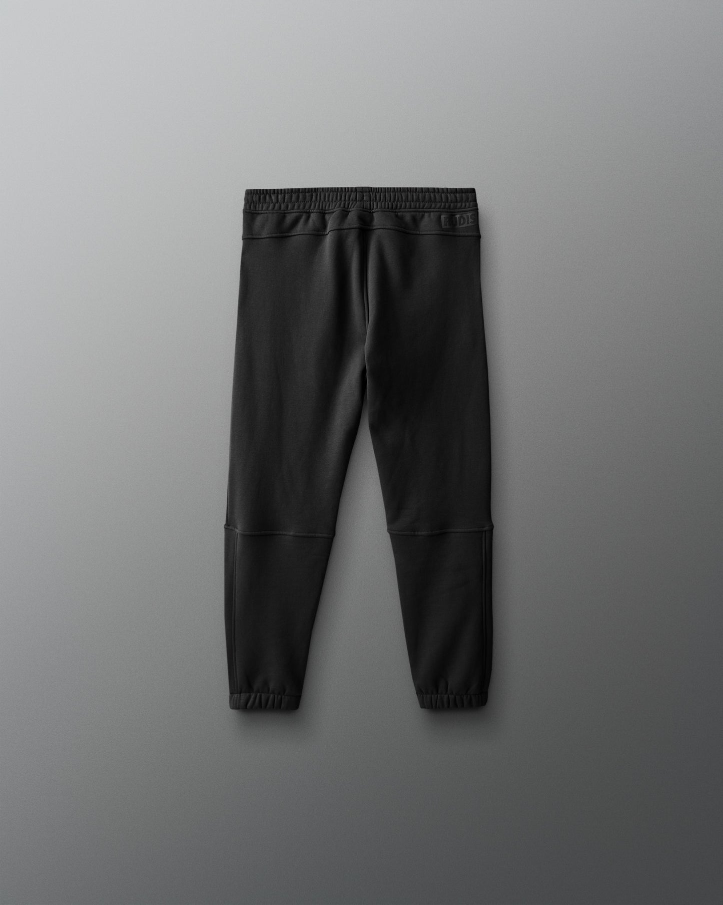 Black jogger pants on a gray background