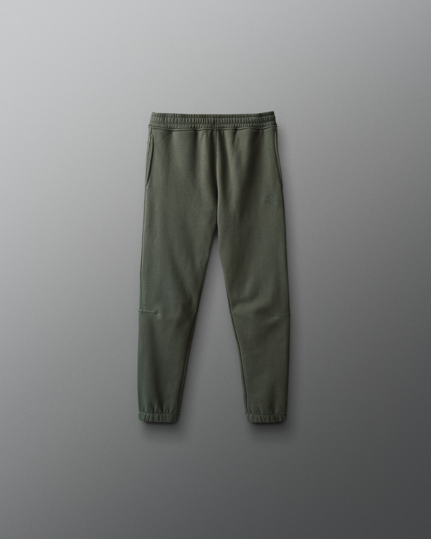 Green jogger pants on a gray background