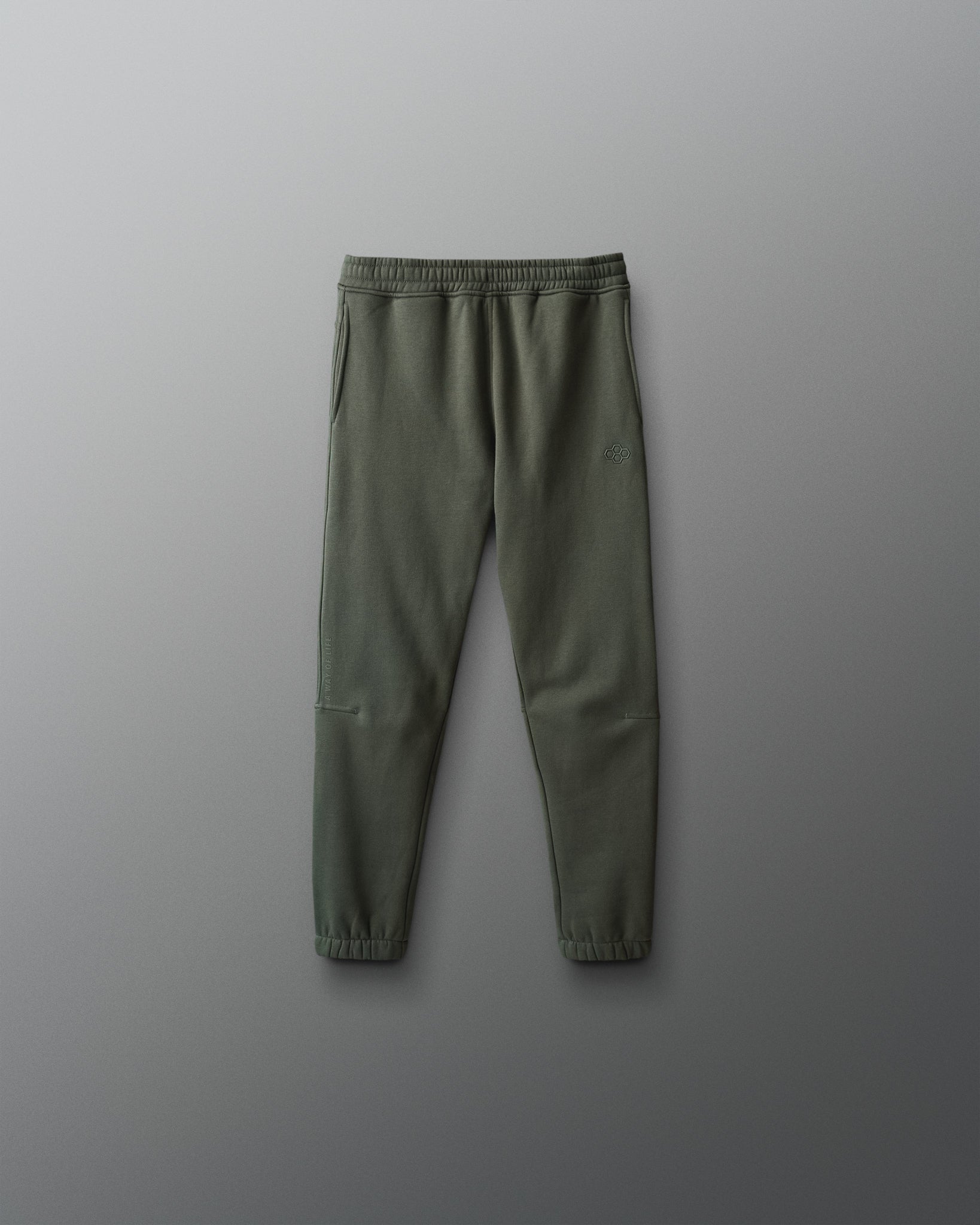 Green jogger pants on a gray background