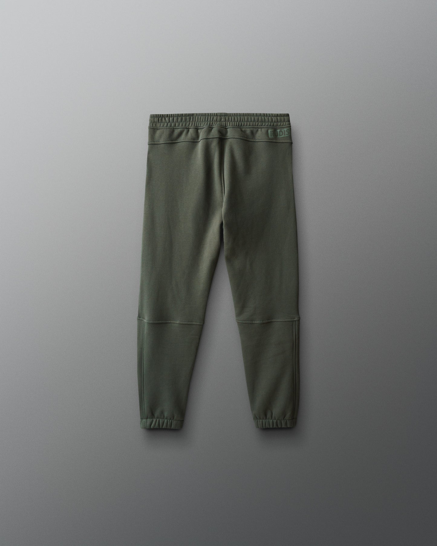 Green jogger pants on a gray background