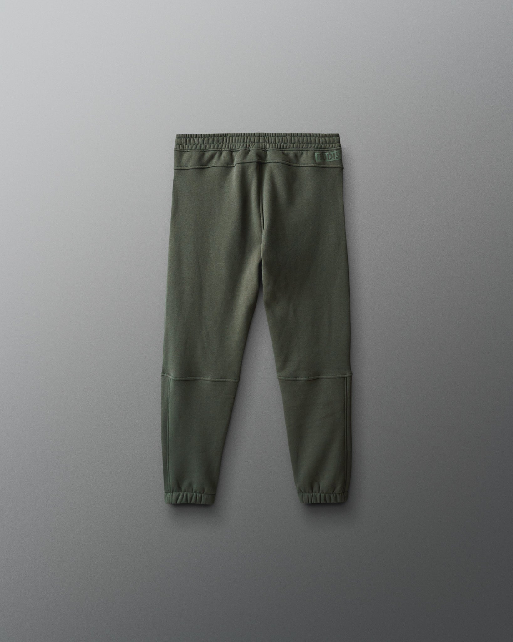 Green jogger pants on a gray background