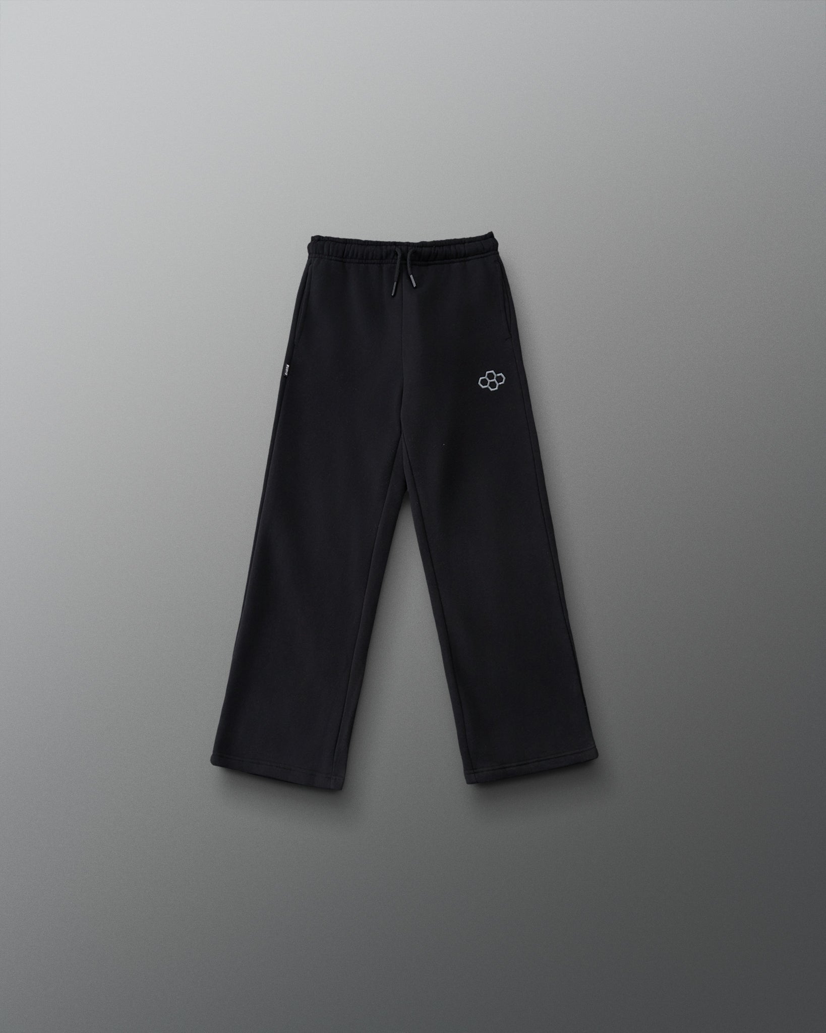 RUDIS Youth Comfort Fleece Wide Leg Sweatpant in Black, front view featuring a relaxed wide-leg fit, adjustable drawstring waistband, side pockets, and gray RUDIS logo. Copy Alt Text