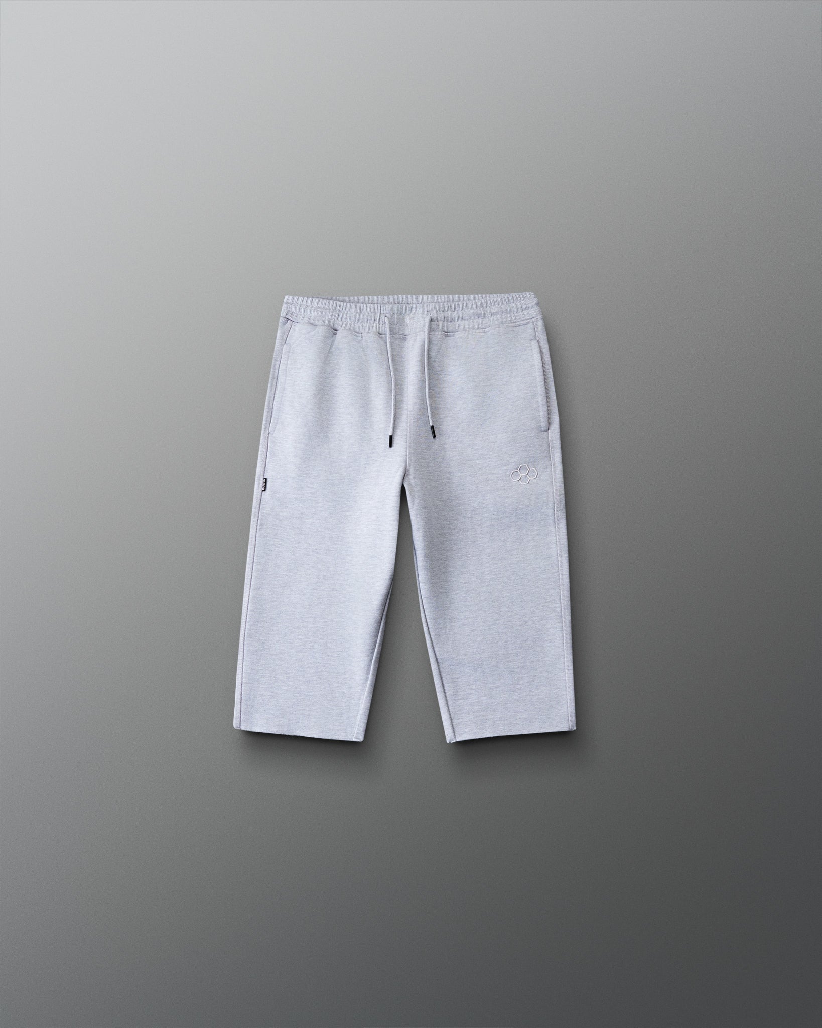 Front view of the RUDIS Youth Titan Heavyweight Cut-Off Sweatpants in heather gray with drawstring waist, side pockets, and RUDIS logo.