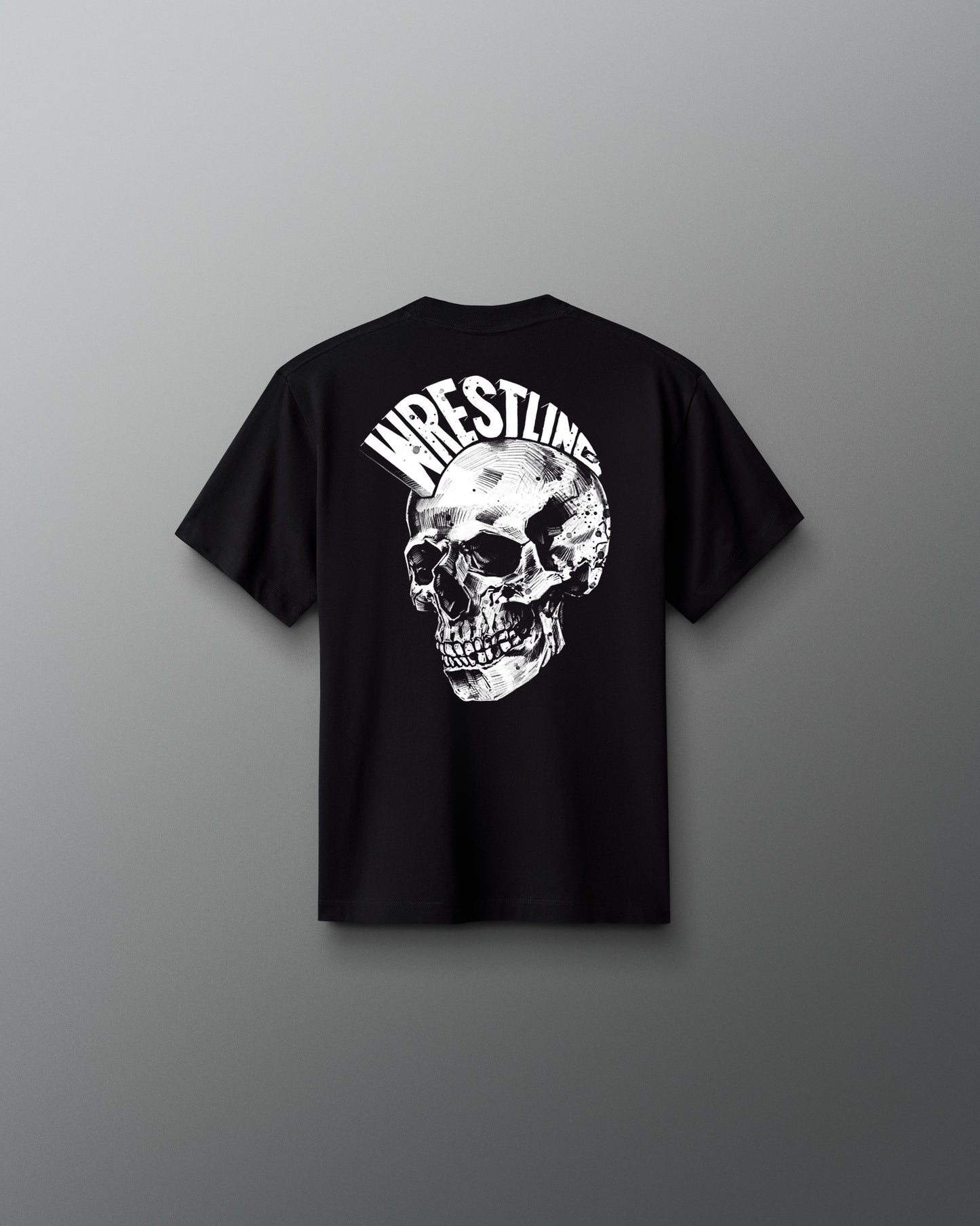 Back view of a black T-shirt featuring a large, detailed white skull graphic with the word ‘WRESTLING’ arched above it in bold, stylized letters.
