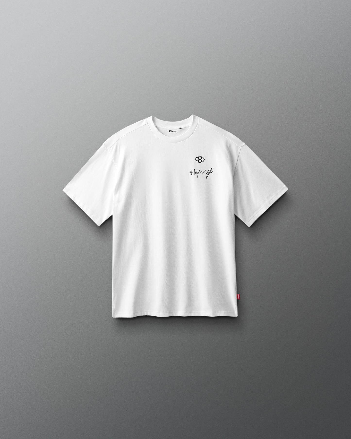 White t-shirt with a small logo on a gray background