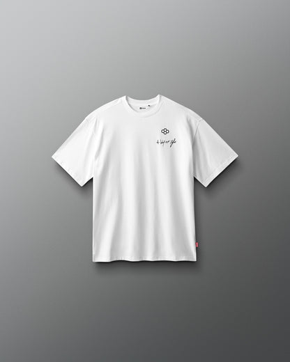 White t-shirt with a small logo on a gray background