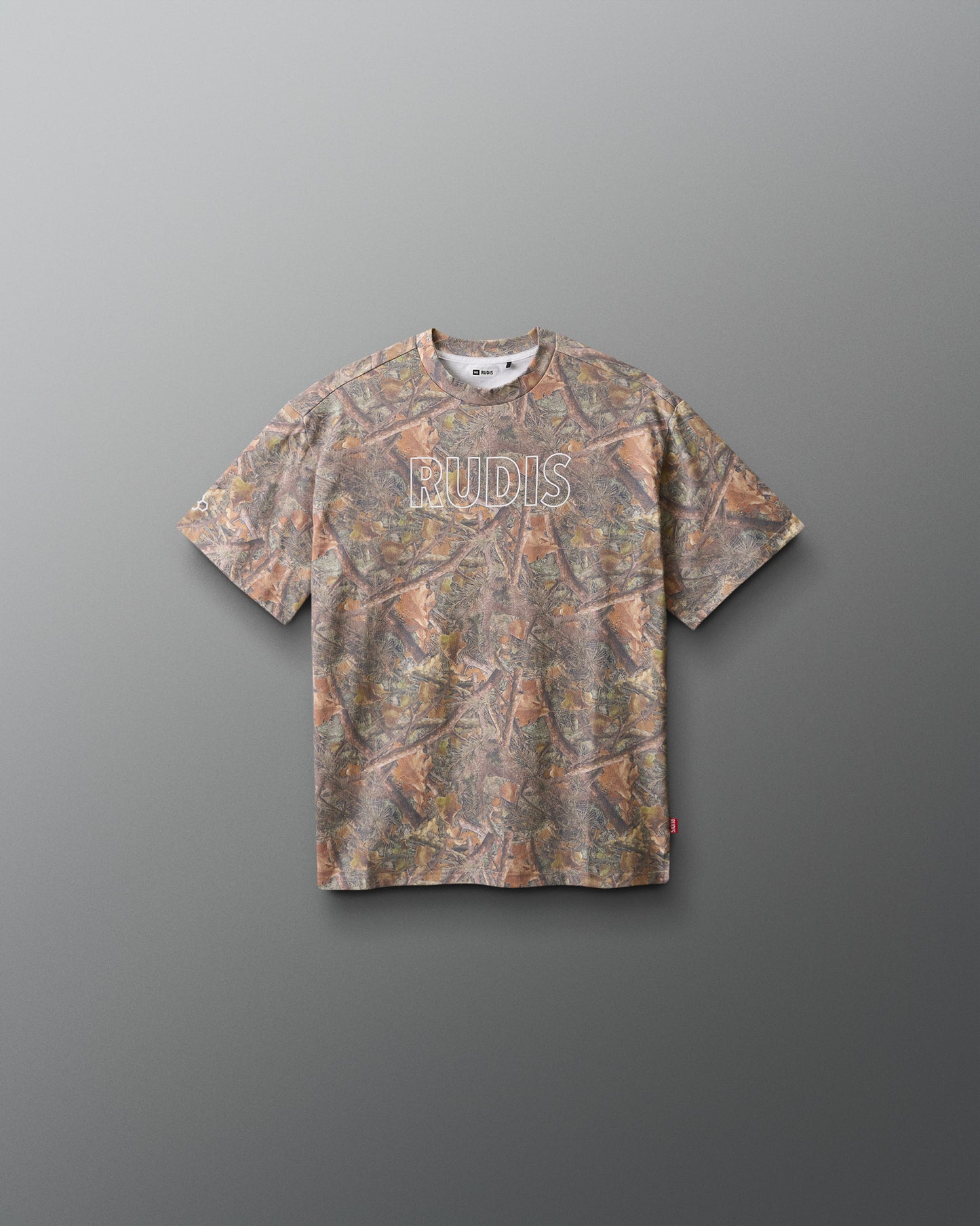 Camouflage-patterned t-shirt with 'RUDIS' branding on a gray background