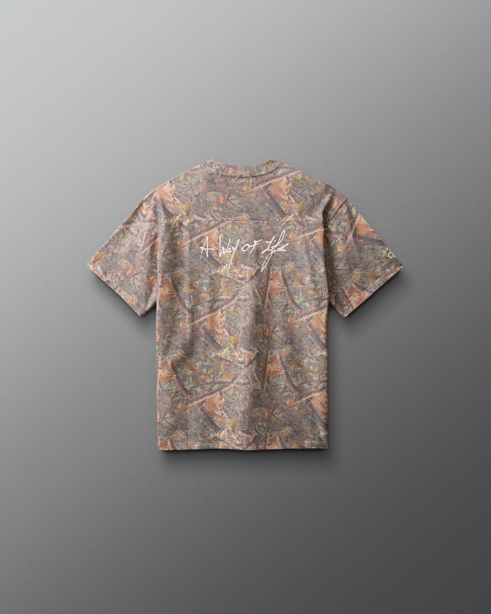Camouflage-patterned t-shirt on a gray background