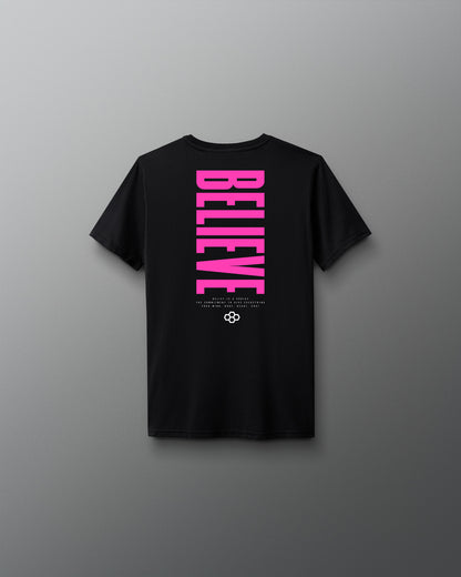 Black t-shirt with pink 'BELIEVE' text on a gray background
