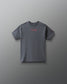 A dark gray crewneck t-shirt with a small pink script logo on the chest reading 'to have a girl' and a small pink logo on the sleeve, displayed against a dark gray gradient background.
