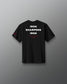 A plain black short-sleeve crewneck t-shirt shown from the back, centered against a neutral gray gradient background.
