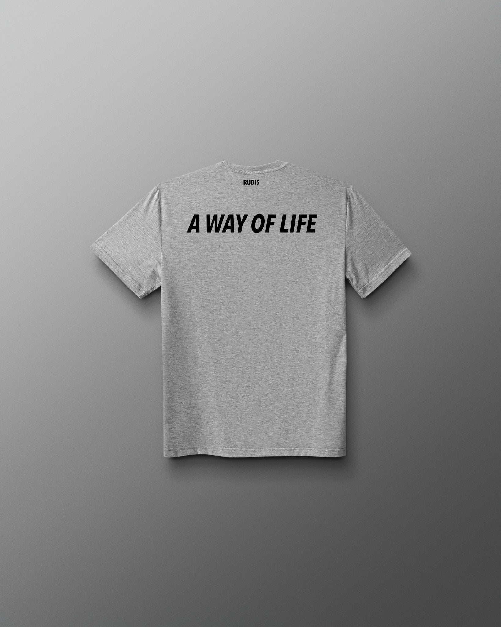 A light heather gray short-sleeve t-shirt with the phrase 'A WAY OF LIFE' printed in bold black capital letters across the chest, displayed against a dark gray gradient background.