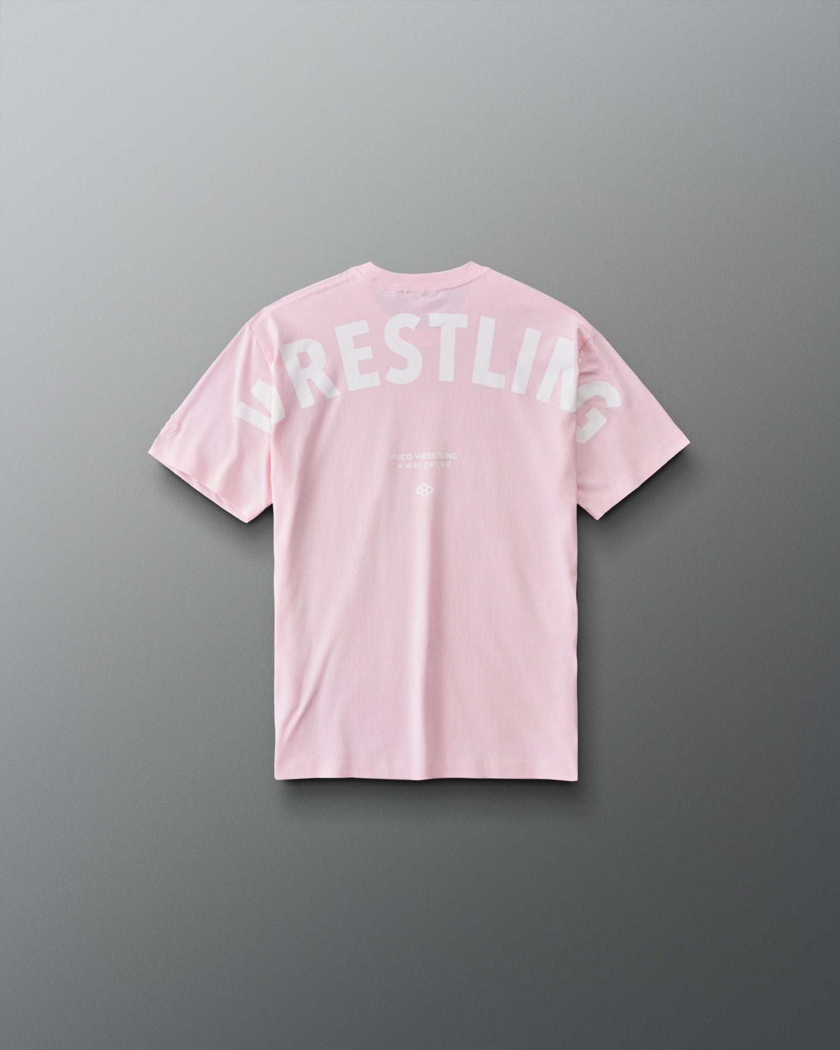 Back view of RUDIS youth wrestling T-shirt in Washed Pink with oversized white WRESTLING lettering and A WAY OF LIFE graphic.