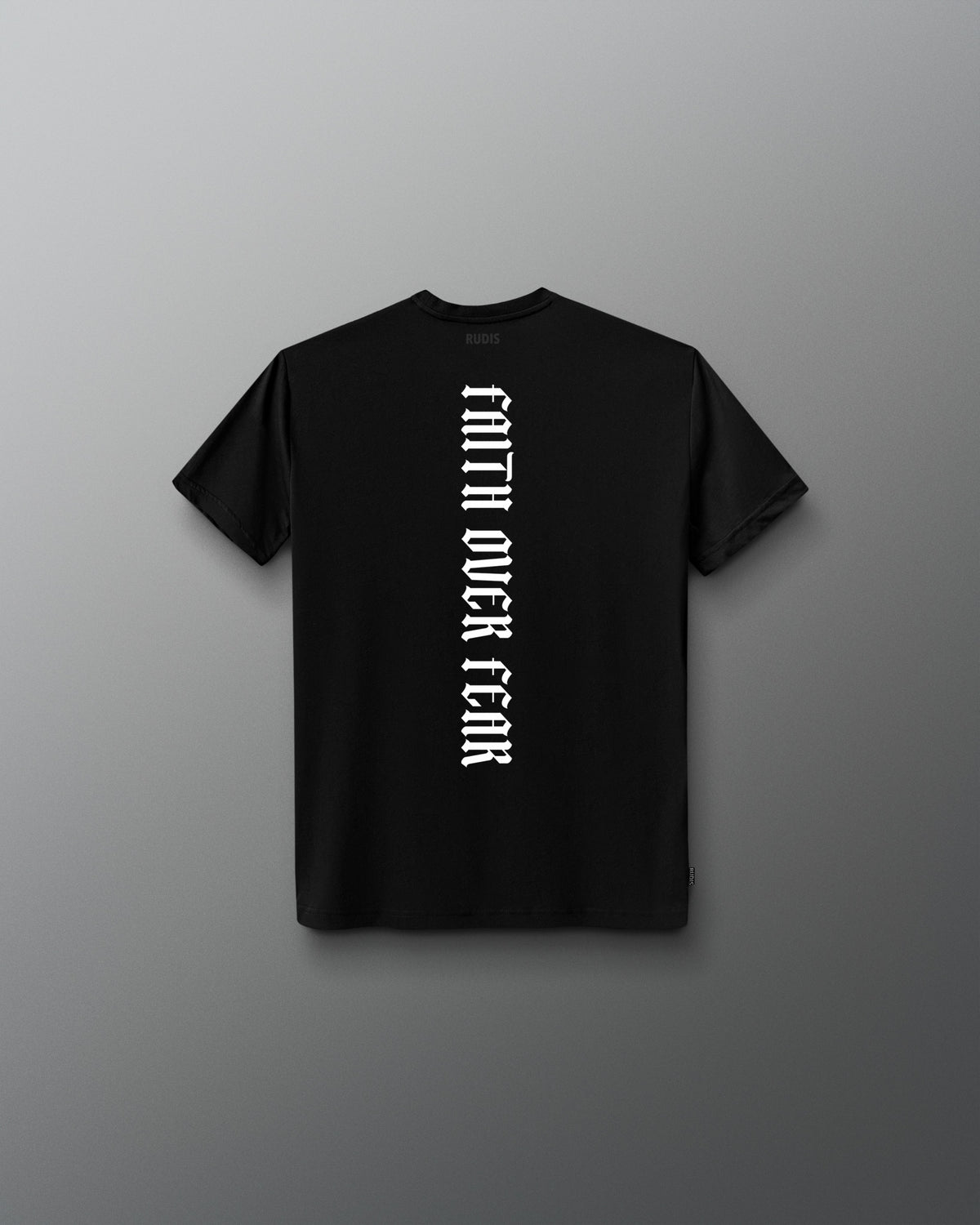 Back of the black RUDIS Cross Youth Elite Super Soft T-Shirt featuring vertical white “Faith Over Fear” lettering and tonal RUDIS neck branding.