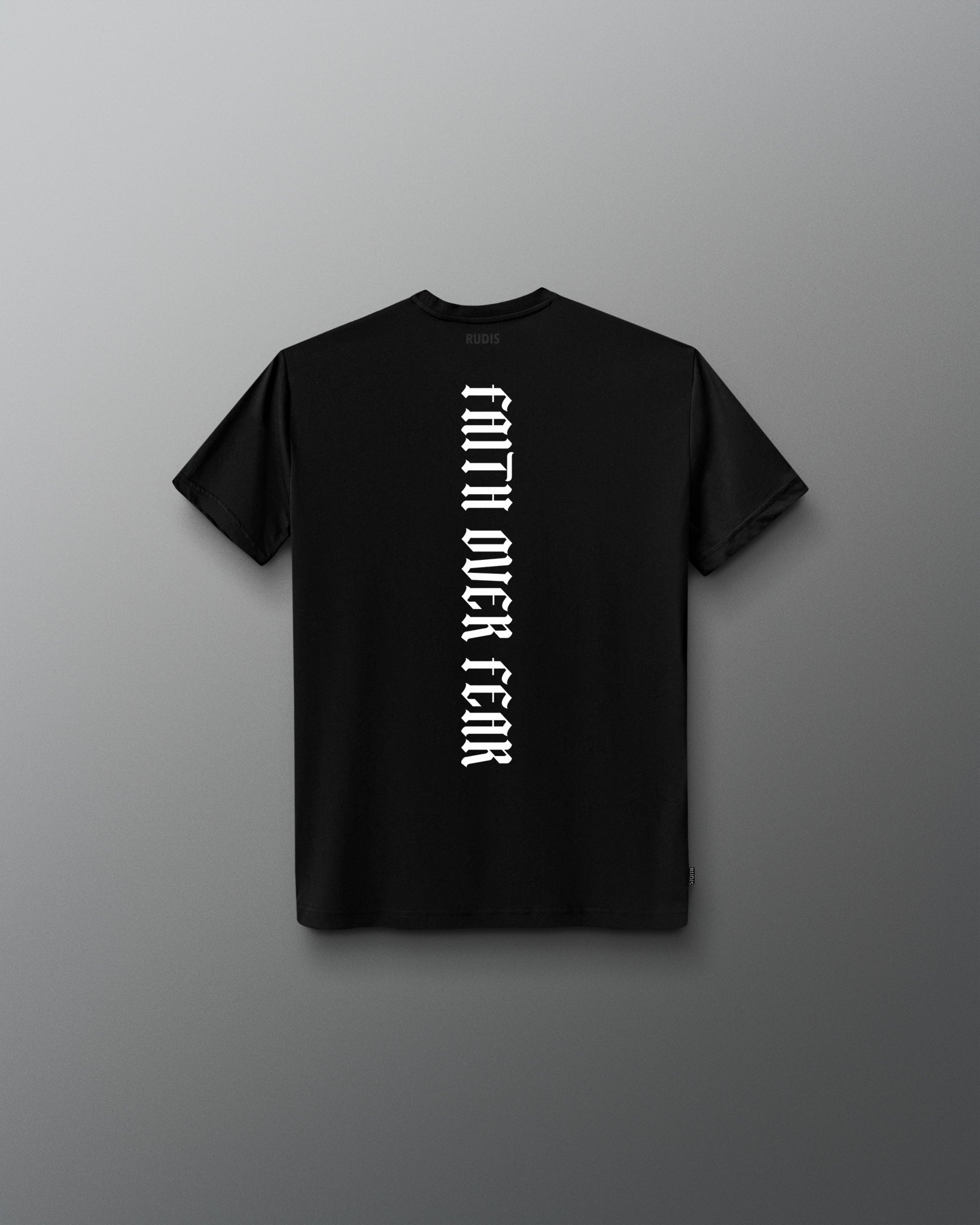 Back of the black RUDIS Cross Youth Elite Super Soft T-Shirt featuring vertical white “Faith Over Fear” lettering and tonal RUDIS neck branding.