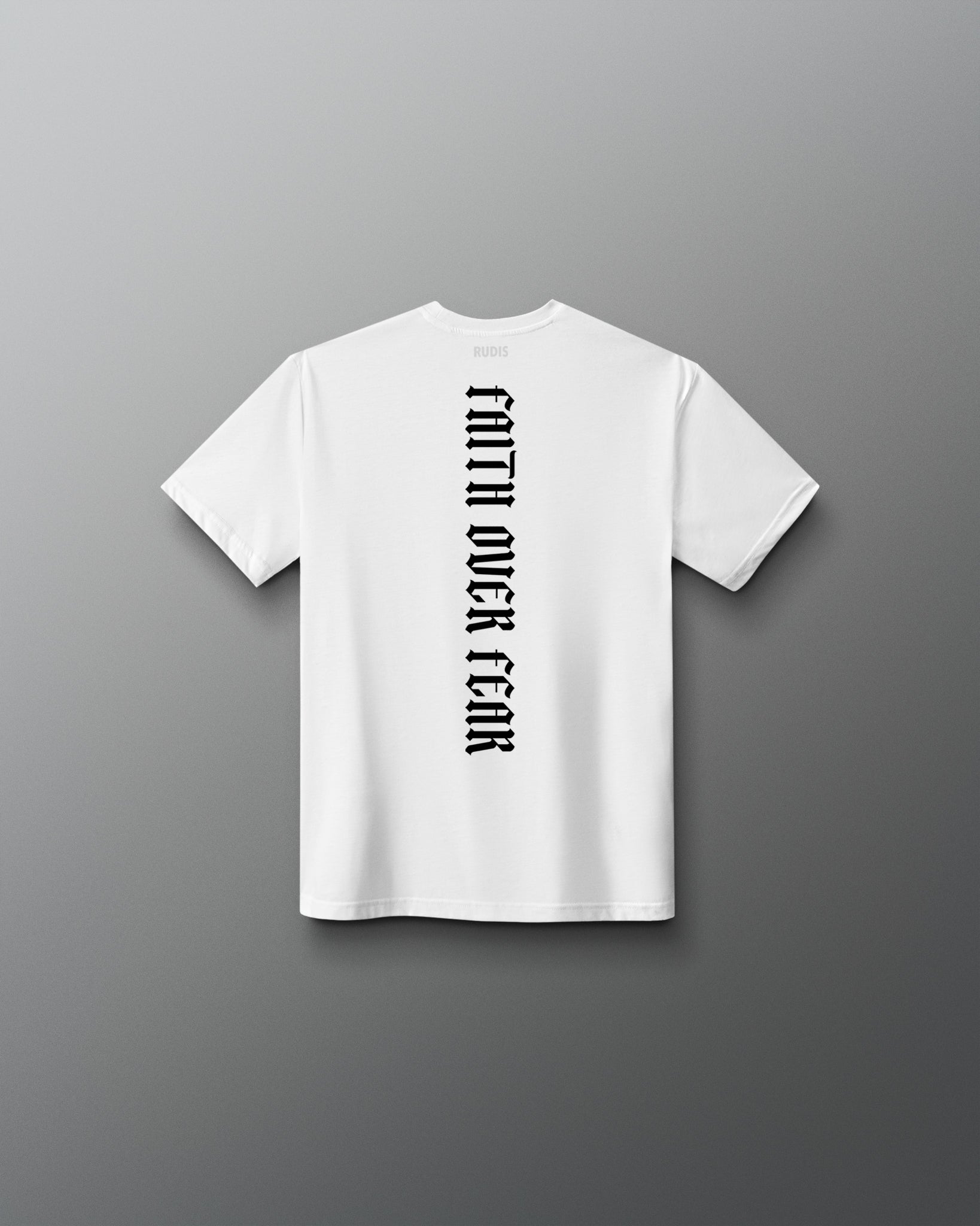 Back of the white RUDIS Cross Youth Elite Super Soft T-Shirt featuring vertical black “Faith Over Fear” lettering and RUDIS neck branding.