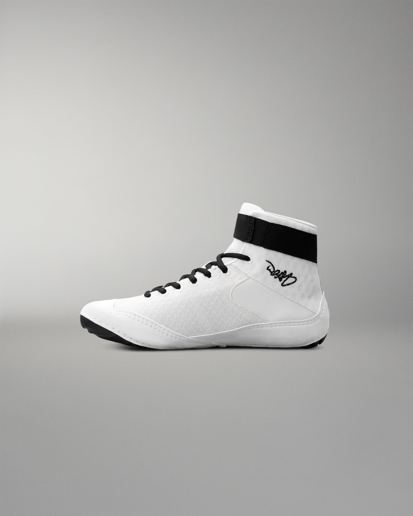 White wrestling shoe with black accents on a gray background