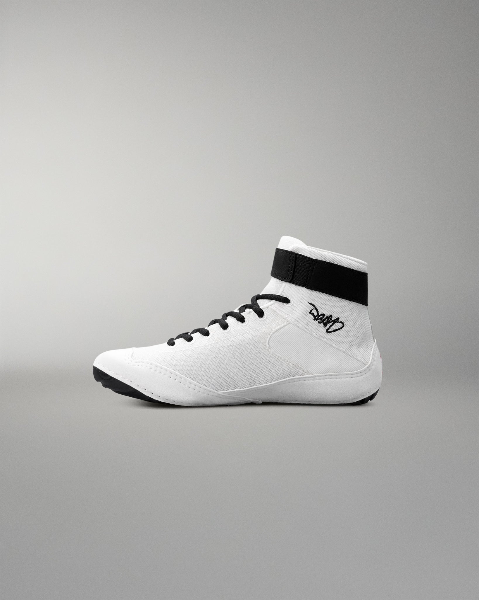White wrestling shoe with black accents on a gray background