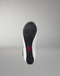 Sole of a wrestling shoe with a red logo on a gray background
