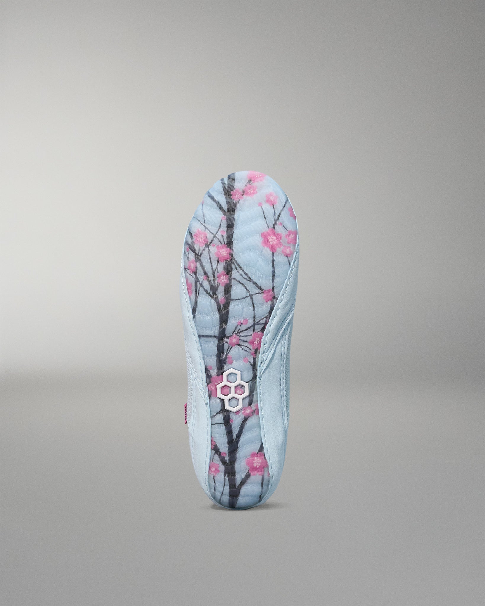 Insole with cherry blossom design on a gray background