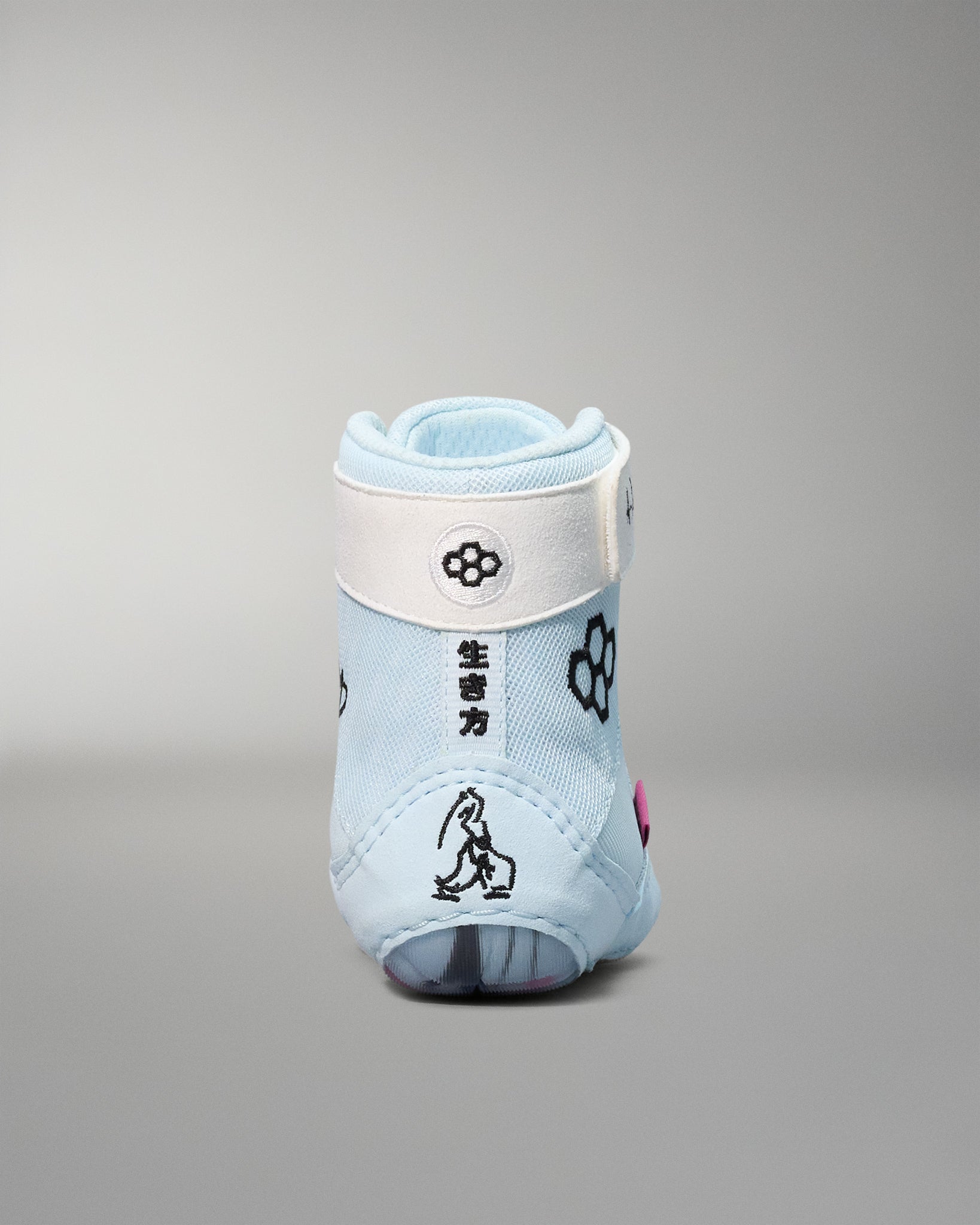 Light blue wrestling shoe with floral prints on a gray background