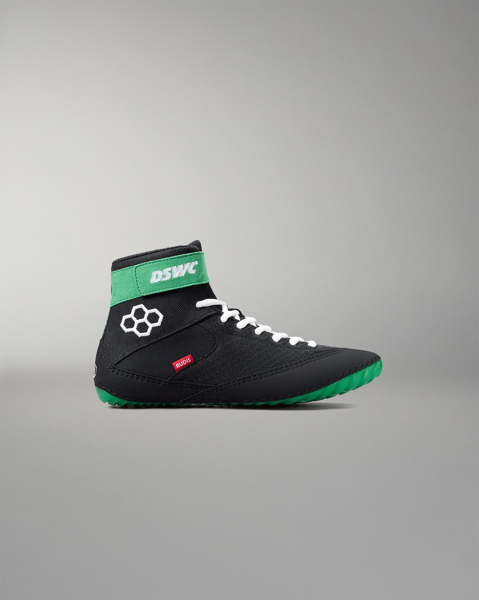 Black and green wrestling shoe with white laces on a gray background