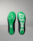 Green and black wrestling shoe insoles on a gray background