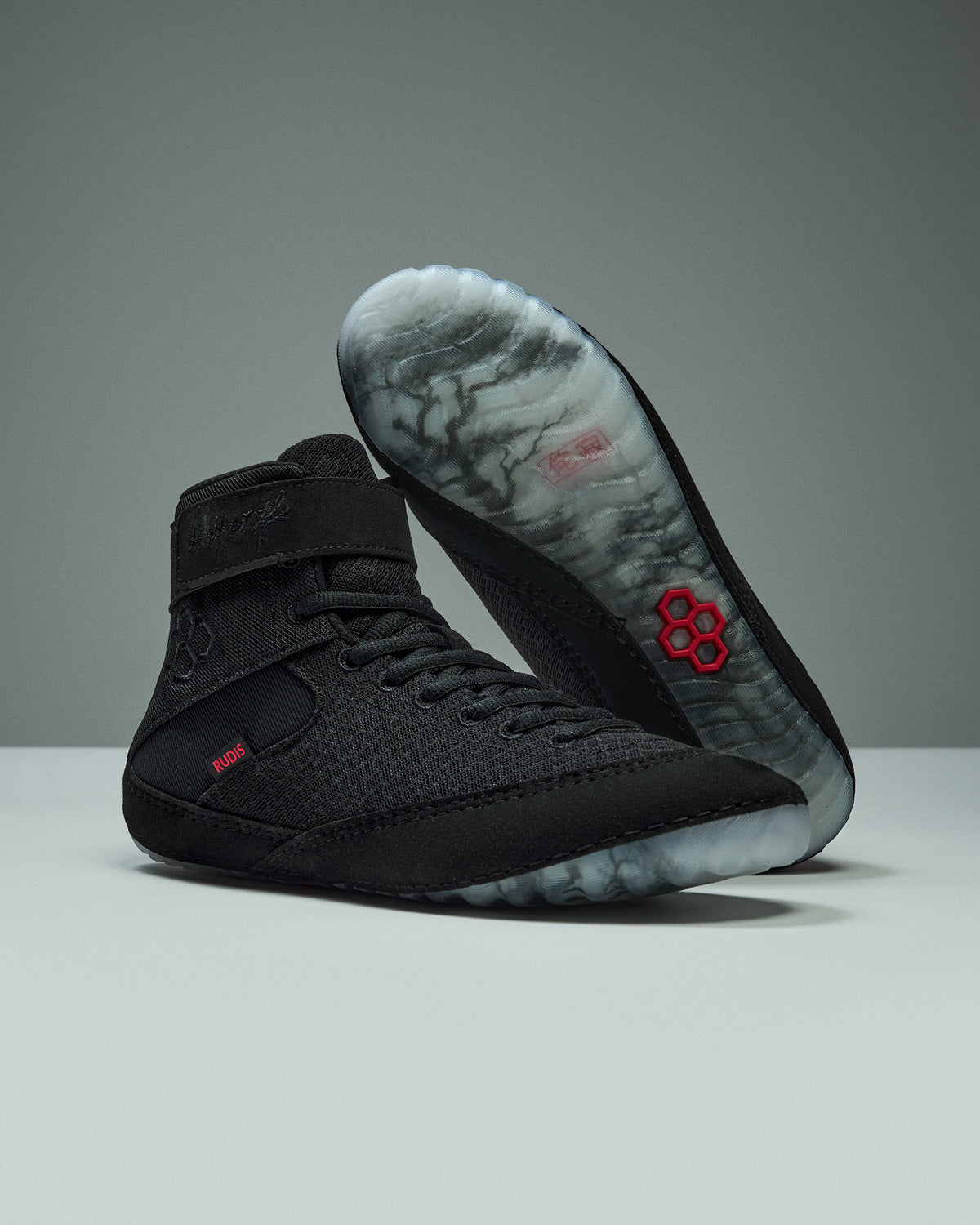 RUDIS Samurai Speed Youth Wrestling Shoes in Wabi-Sabi black, showing textured mesh uppers, red accents, ankle straps, and translucent outsoles with Japanese-inspired artwork.