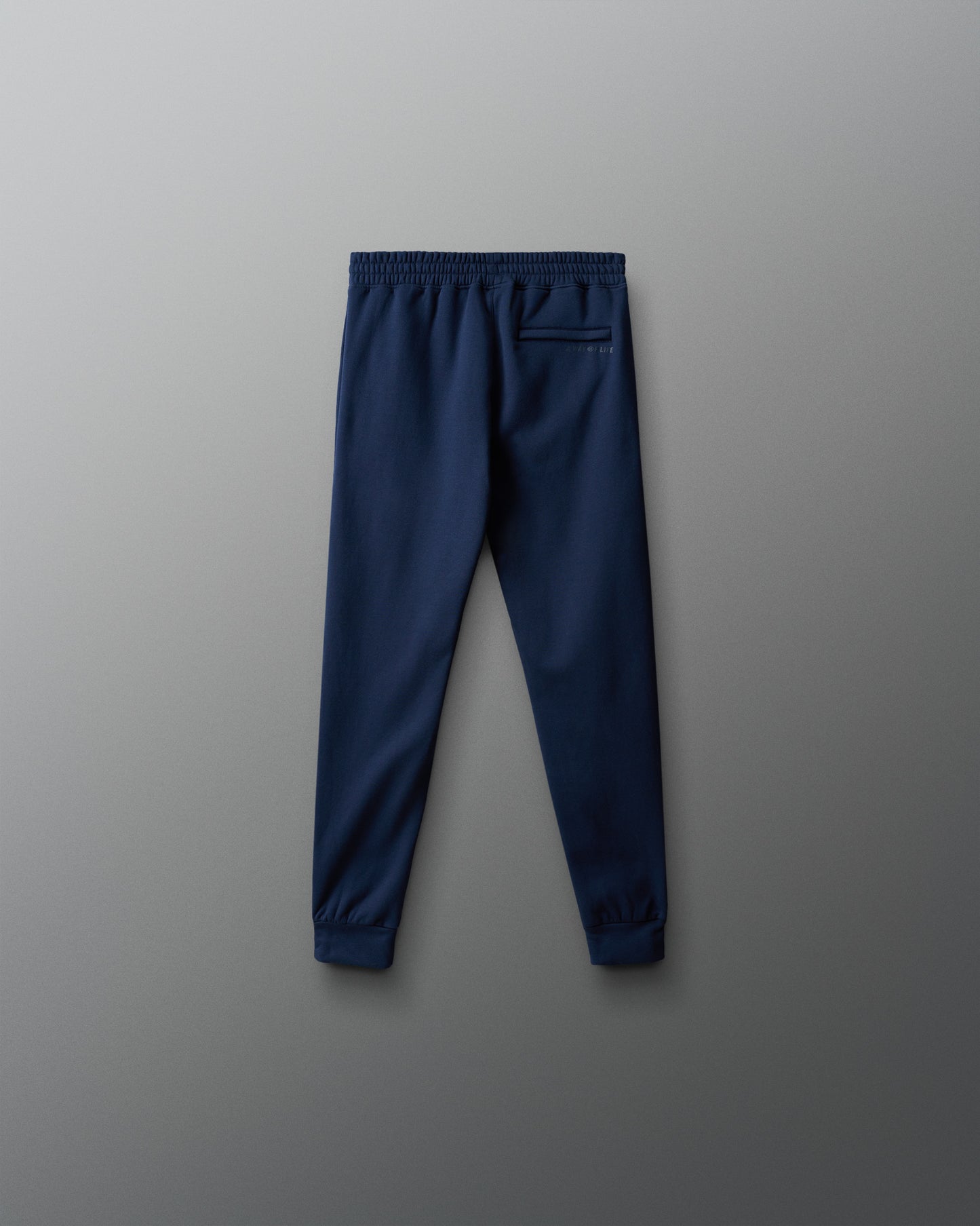 Navy blue jogger pants on a gray background