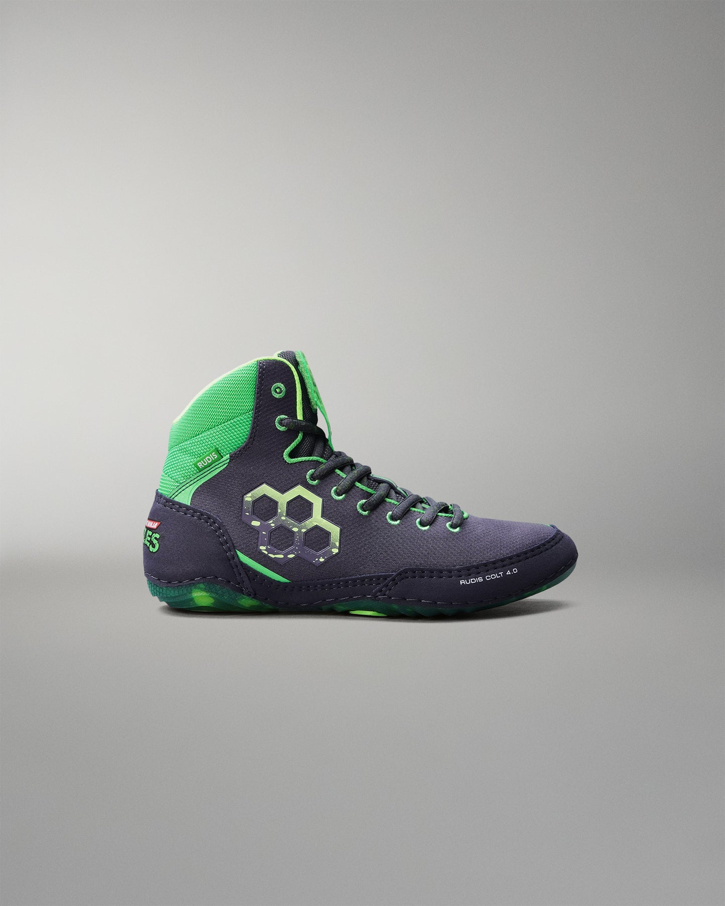 Wrestling shoe with green and purple design on a gray background