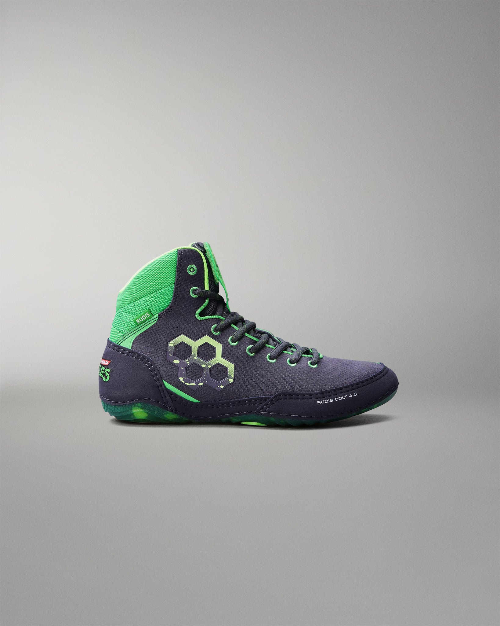 Wrestling shoe with green and purple design on a gray background