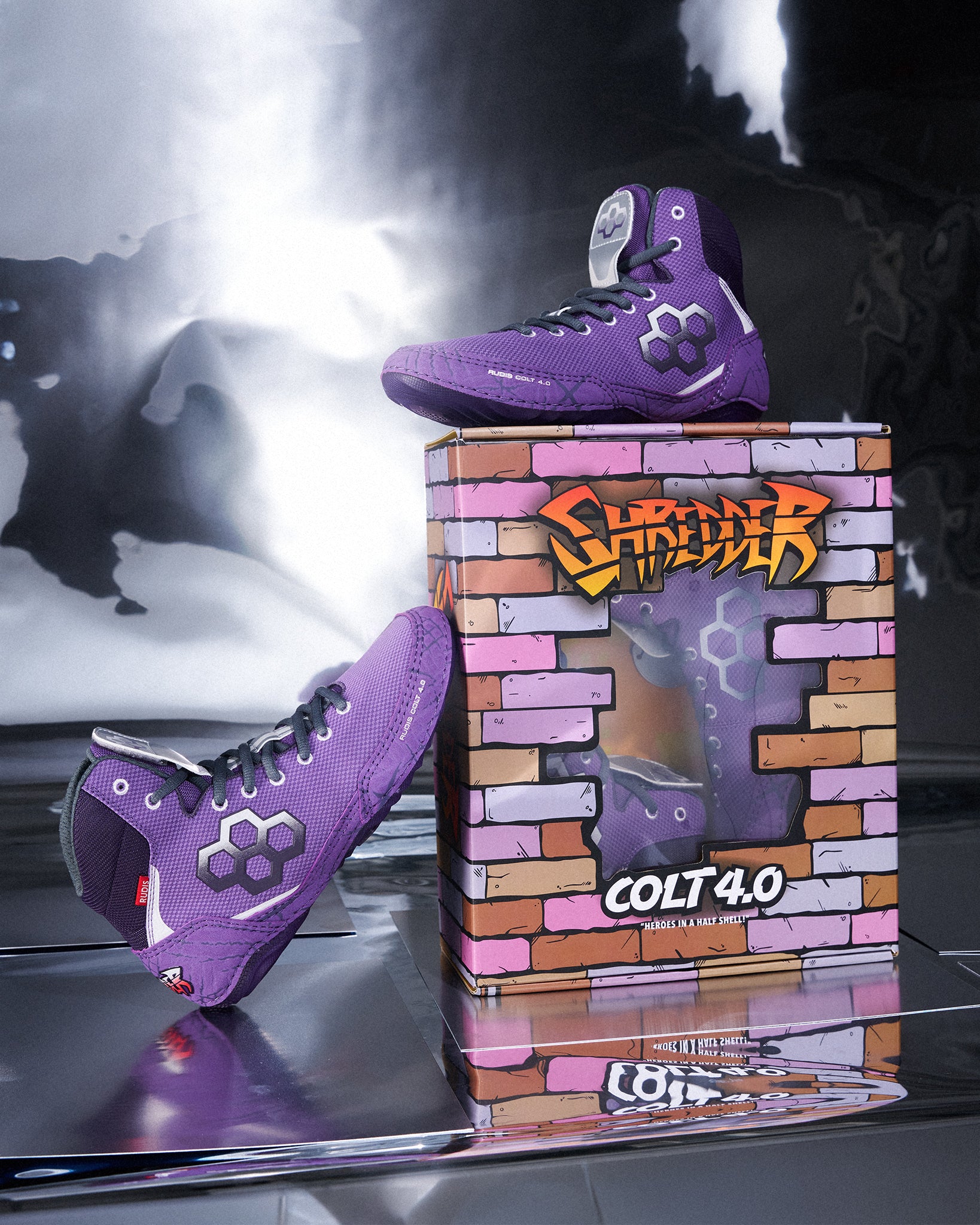 Youth RUDIS Colt 4.0 Shredder wrestling shoes in purple displayed alongside exclusive TMNT-inspired collector packaging, featuring custom Shredder artwork and a premium product presentation.