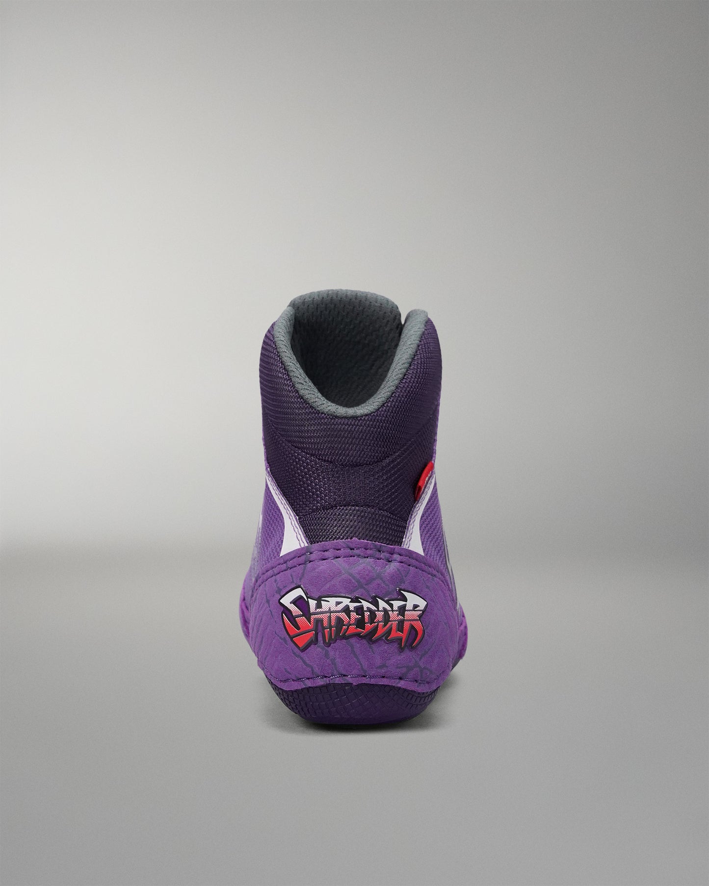 Rear view of the RUDIS Colt 4.0 Shredder wrestling shoe in purple, featuring exclusive Shredder heel branding, a padded high-top collar, and a performance-focused design built for comfort and support on the mat.