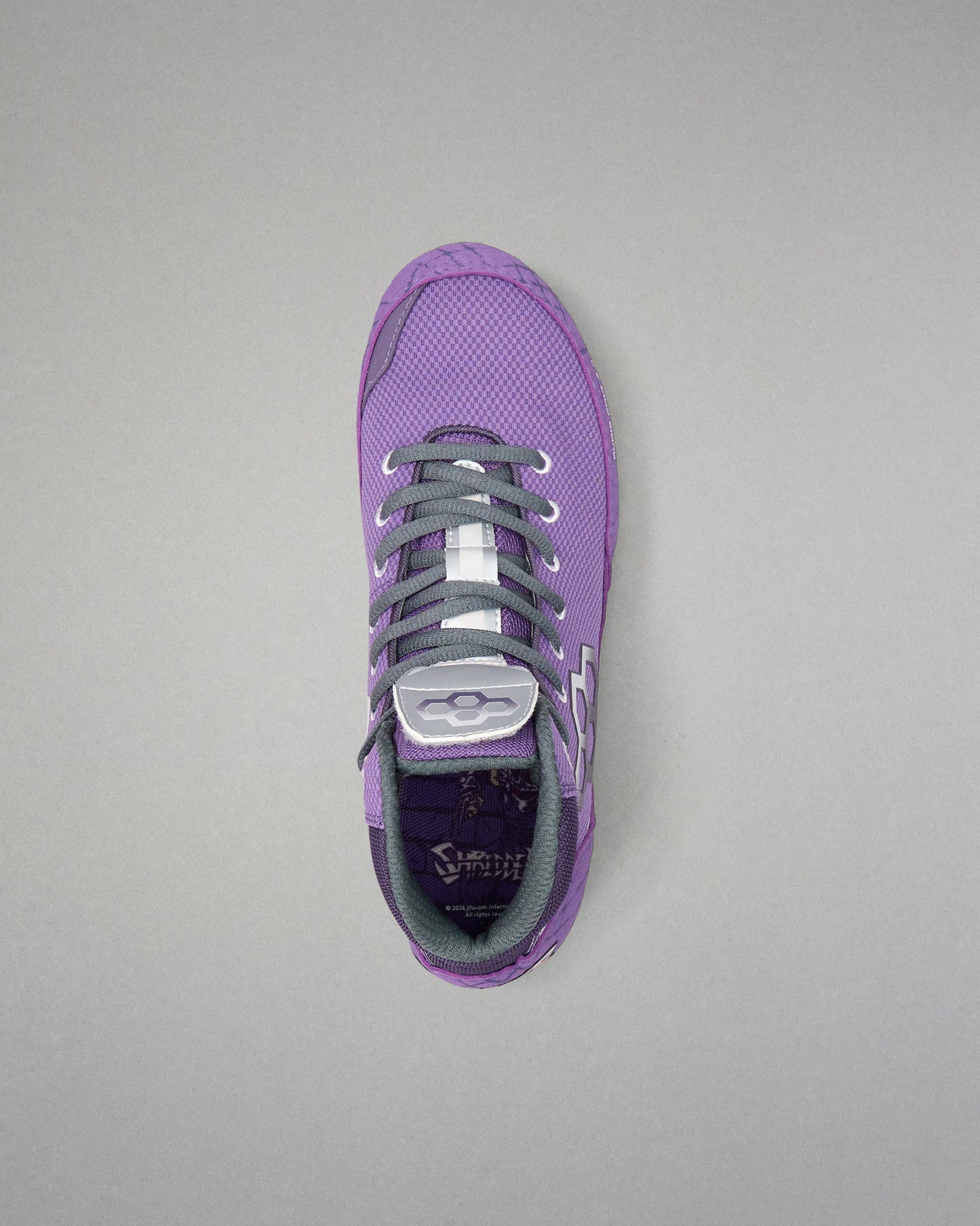 Top-down view of the RUDIS Colt 4.0 Shredder wrestling shoe in purple, highlighting the breathable mesh upper, secure gray lace system, padded collar, and TMNT-inspired interior graphics.