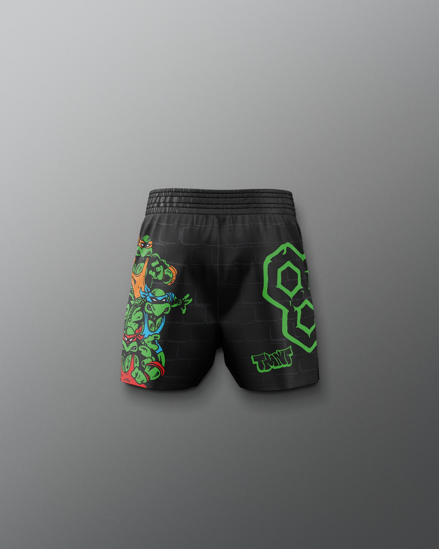 Black shorts with colorful designs on a gray background. TMNT. Teenage Mutant Ninja Turtle