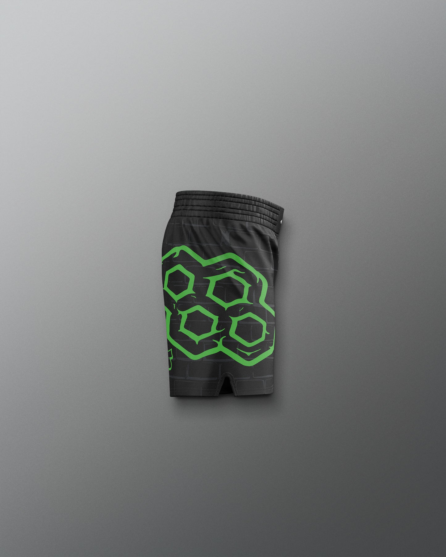 Black shorts with green geometric pattern on a gray background. TMNT. Teenage Mutant Ninja Turtle
