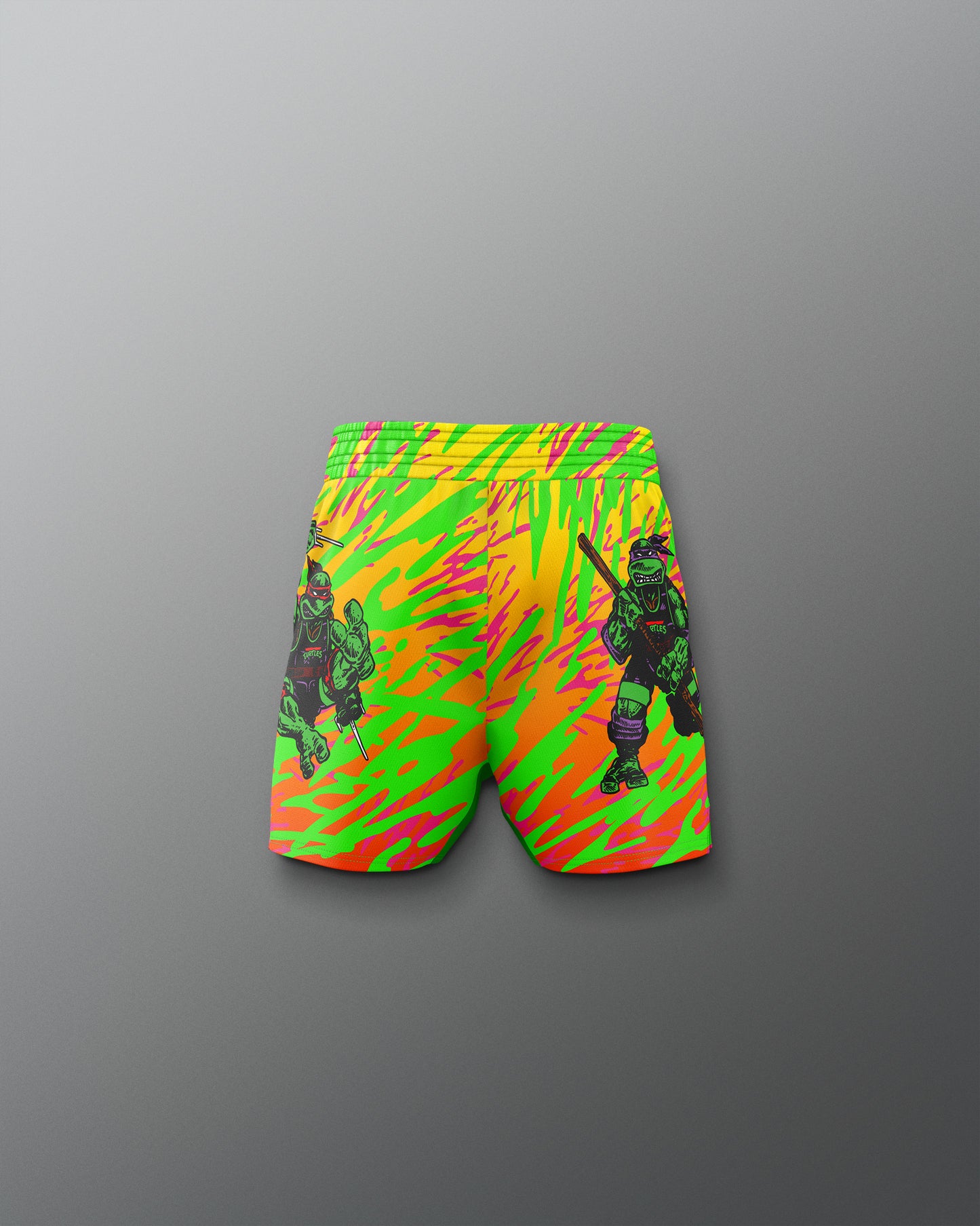Neon green and orange shorts with graphic design on a gray background