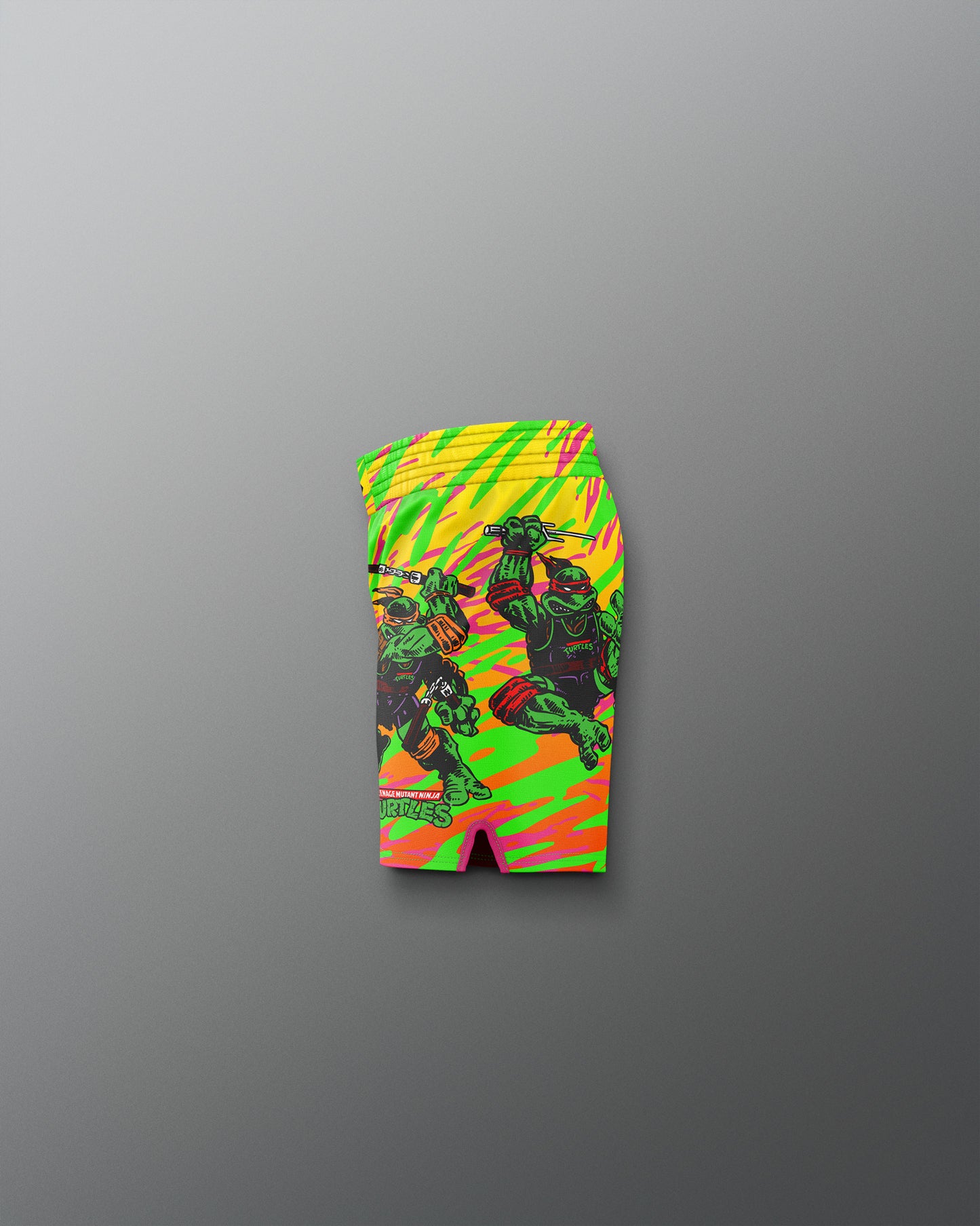 Colorful swim shorts with a graphic design on a gray background