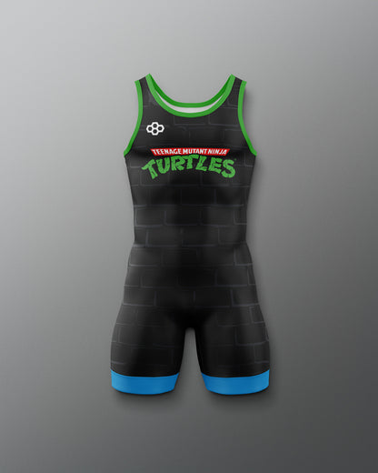 Black wrestling singlet with green and red text saying "teenage mutant ninja turtles" on a gray background