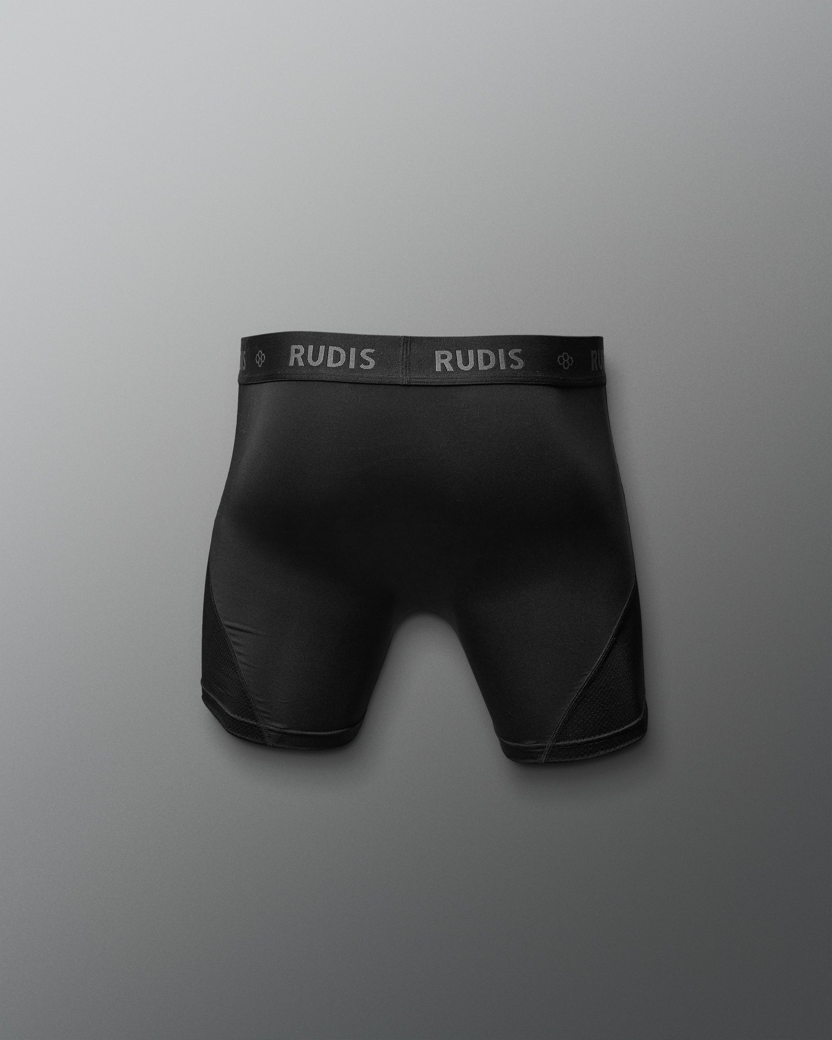 Black boxer briefs with 'RUDIS' branding on a gray background
