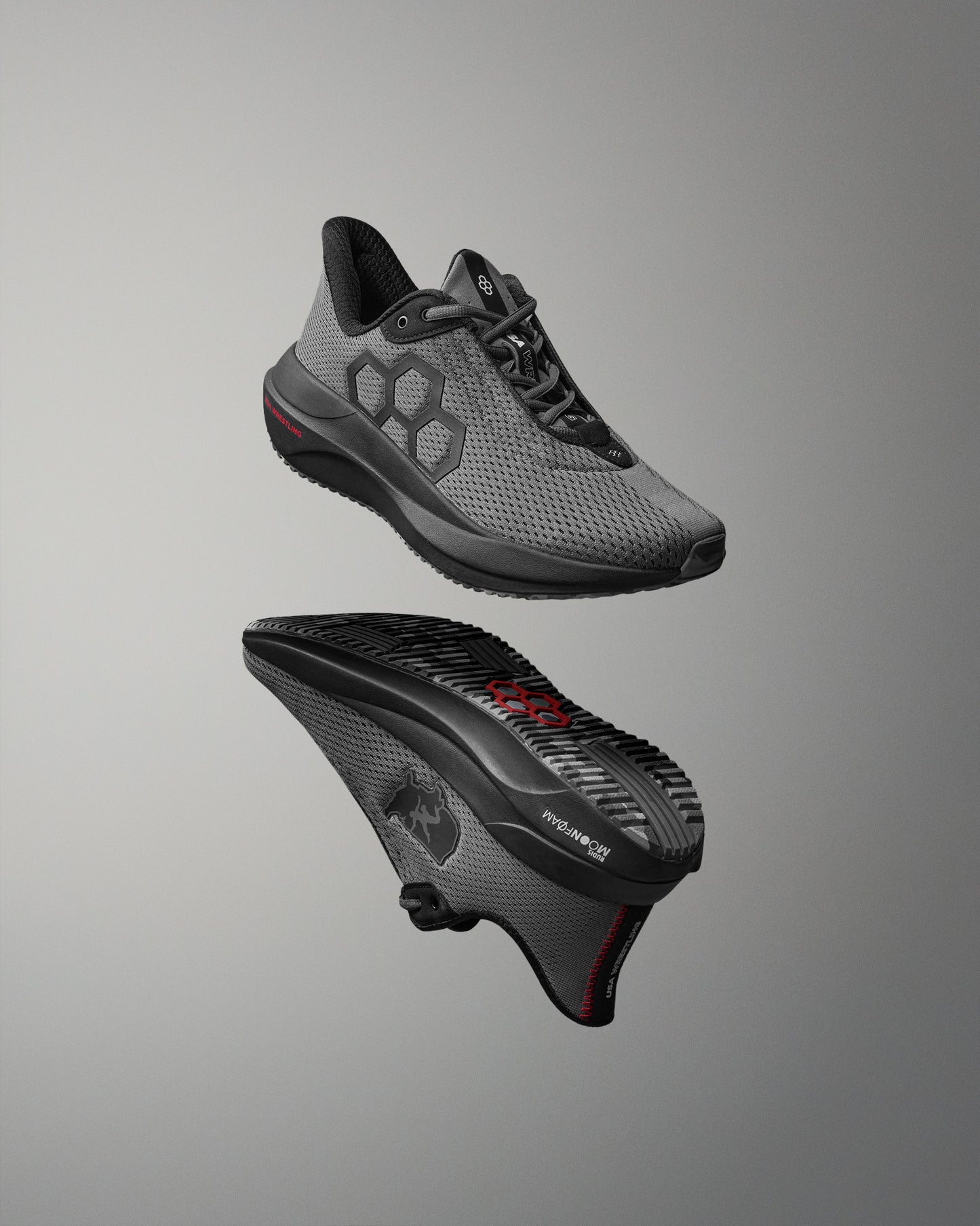 Gray athletic shoe with black sole on a gray background