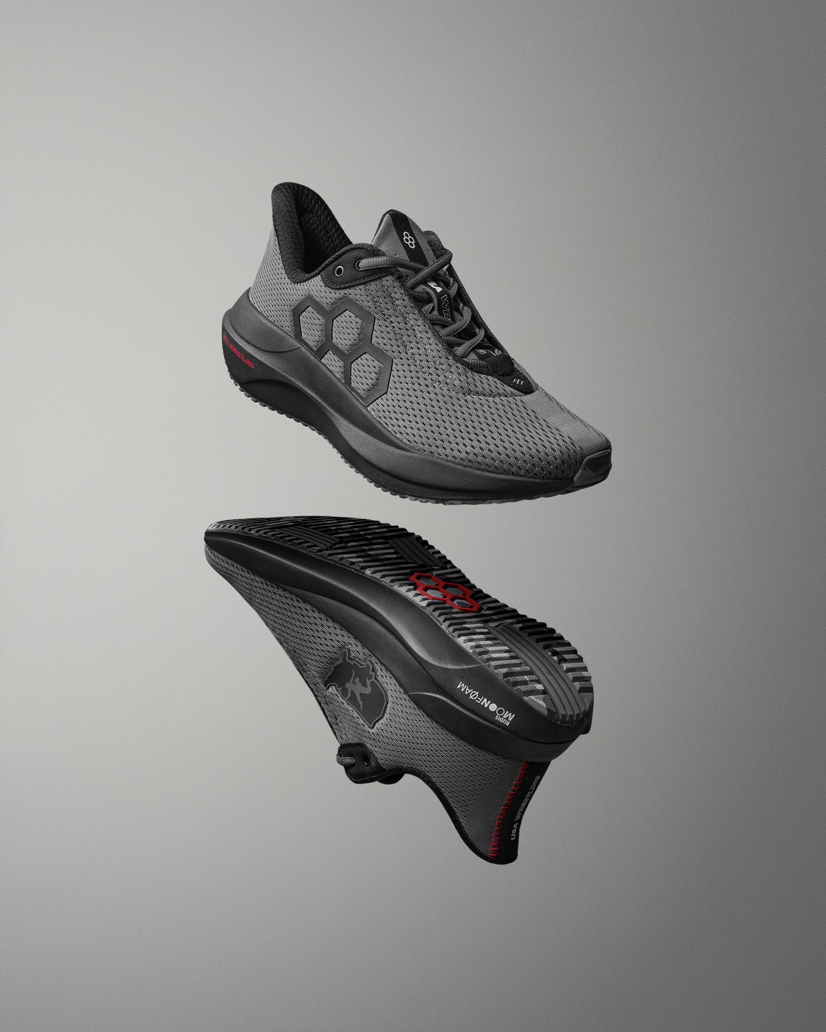 Gray athletic shoe with black sole on a gray background