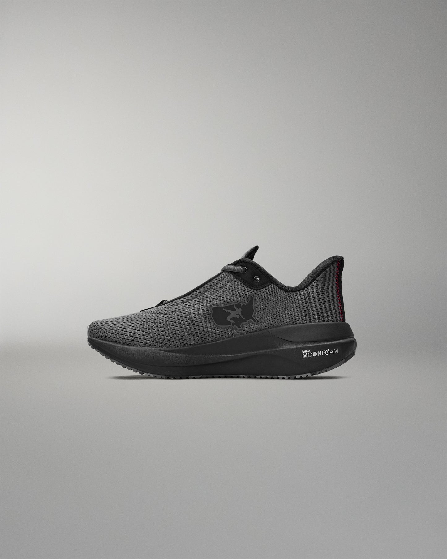 Black athletic shoe on a gray background